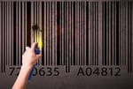 Hand drawing a barcode on the wall